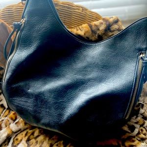 Women’s Handbag, black vegan leather. Lots of zippers and compartments.